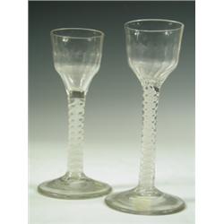 Two 18th Century cordial glasses with panelled ogee bowls on double strand opaque twist stems,...