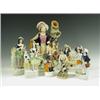 Image 1 : A collection of seven Victorian Staffordshire figures, comprising: A large figure of a huntsma...