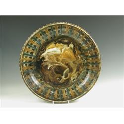 An earthenware lead glazed slipware charger, probably French c.1860, 43cm diameter Est. 80/...