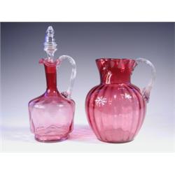 A Victorian cranberry glass jug and decanter, 18cm and 26cm respectively. Est. 100/150...