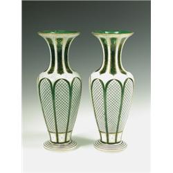 A pair of mid 19th Century green glass, white overlay vases cut with panels and gilt stiff lea...