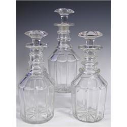 Three 19th Century decanters with mushroom style stoppers and three neckrings above facetted b...