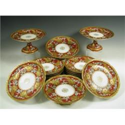A late 19th Century eighteen piece Limoges porcelain dessert service, comprising twelve tall t...