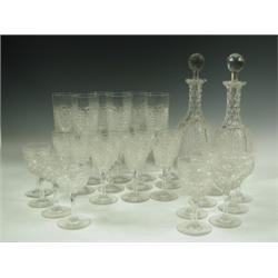 An Edwardian cut glass suite, comprising: two decanters with facetted necks, eleven port glass...
