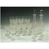 Image 1 : An Edwardian cut glass suite, comprising: two decanters with facetted necks, eleven port glass...