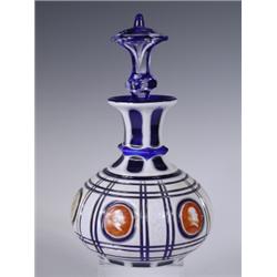 A 19th Century blue glass decanter, with roundels with hand painted medieval busts in profile,...