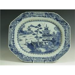 A large Chinese blue and white octagonal meat dish painted with a pagoda in a lake landscape,...