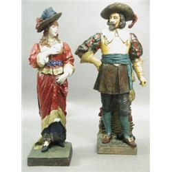 A pair of large early 20th Century Goldscheider figurines, modelled as a cavalier and female c...