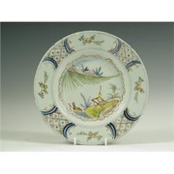 An 18th Century delft plate, decorated in polychrome colours, with a chinoiserie centre, 22cm...