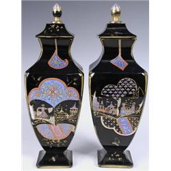 A pair of late l9th Century lidded black glass vases with polychrome Japanesque style decorati...