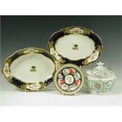 A pair of Derby dishes of oval form, each painted with a crest to the centre, of a crow on a s...