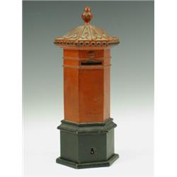 A Victorian painted iron moneybox in the form of a postbox Est. 150/200...