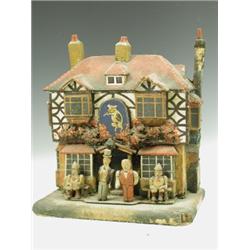 A late 19th Century model money box: 'The Pig and Whistle Pub' with figures, composition over...