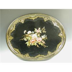 A Victorian, oval papier mache tray, with a painted border and a central floral painted spray,...