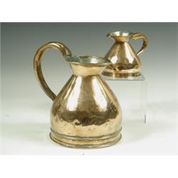 A 19th Century copper quart measure of waisted bulbous form, having a flared lip and applied h...