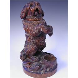 A late l9th Century carved wood tobacco pot in the form of a begging dog, 34.5cm high. Est....