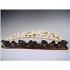 Image 1 : A late l9th Century Japanese carved ivory tusk on a carved wood base, length of tusk 31.5cm<br...