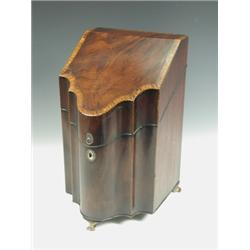 A George III strung and crossbanded mahogany knife box, of serpentine shape with a fitted inte...