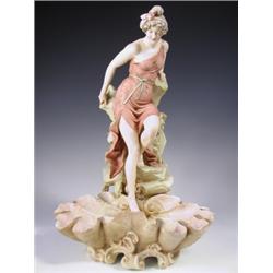 An early 20th Century Royal Dux figurine, modelled as a young maiden descending from a rocky m...