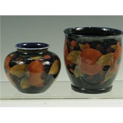 Two small William Moorcroft Pomegranate pattern vases with berries and leaves to the backgroun...