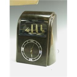 A Vitascope brown Bakelite clock with a chrome chapter ring and hands below a ship automata ha...