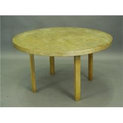 In the style of Alvar Aalto, a beechwood circular centre table on four bentwood legs, bears la...