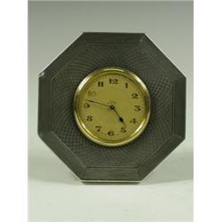 An octagonal silver cased eight day mantel clock, with engine turned decoration, 1924, 10cm di...