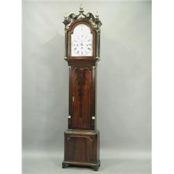 An early 19th Century mahogany longcase clock, the hood with a swan neck cornice, three brass...