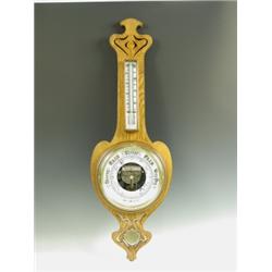An Art Nouveau oak aneroid barometer with carved and pierced decoration, 87cm high Est. 180...