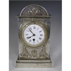 A late l9th/early 20th Century polished pewter arch top mantel clock, with applied strapwork t...