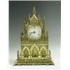 Image 1 : A late Victorian brass cathedral clock, the turreted case with a porcelain dial and a cut plat...
