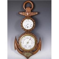 A late Victorian carved oak barometer with clock housed within an anchor shape case by J. Park...