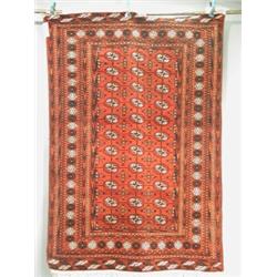 A modern red ground handmade woollen Persian bokhara rug, 1.79 x 1.22m Est. 200/250...