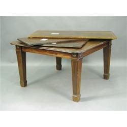 An Edwardian mahogany extending dining table, with three leaves on square tapering and fluted...