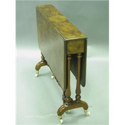 A Victorian burr-walnut Sutherland table with turned supports and brass capped porcelain casto...