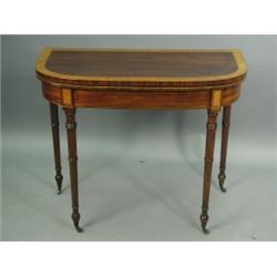 A George III mahogany, satinwood and ebony crossbanded card table standing upon turned and tap...