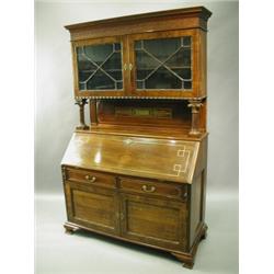 A rosewood bureau bookcase, the upper section with a pair of astragal glazed doors, the brass...
