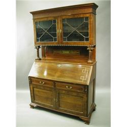 A rosewood bureau bookcase, the upper section with a pair of astragal glazed doors, the brass...