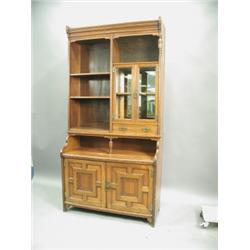 A late Victorian walnut cabinet, of 'Aesthetic' design, with open shelves and a glazed cupboar...