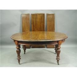 A Victorian mahogany extending dining table having two extra leaves and an additional leaf to...