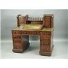 A Victorian mahogany 'Dickens' desk, the top with two columns of drawers, a gallery and a rais...
