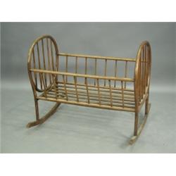 An antique bentwood cot with turned spindle rails and supports, 95cm long Est. 100/150...