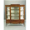 An Edwardian inlaid mahogany breakfront display cabinet, with glazed doors flanking a bevel ed...