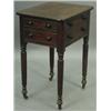 A Regency mahogany work table with a plain moulded top above two cock beaded drawers and dummy...