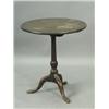 A mahogany tripod table with a twin plank top and turned support standing on three downswept l...