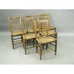 A set of six 19th Century oak spindle and bar back chairs with plain boarded seats 85cm high<b...