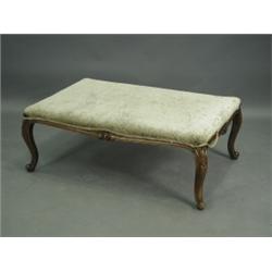 A large Victorian carved walnut fireside stool, raised on a carved apron and cabriole legs, 11...