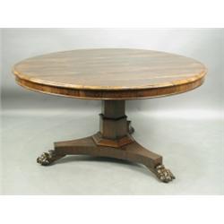 A Regency rosewood breakfast table on lions paw feet, 131cm diameter Est. 1200/1500...