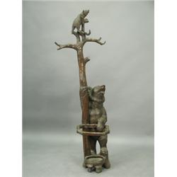 A 19th Century Black Forest Bear hall stand in carved softwood with a cub clinging to the top...