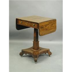 A Regency rosewood drop flap work table, with a single frieze drawer, opposite one dummy drawe...